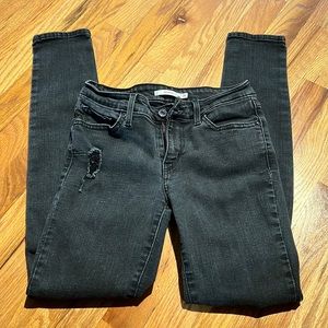 Black Levi’s 711 skinny. Faded black and ripped/ destroyed